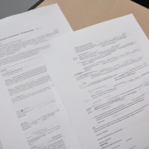 A visual comparison of a poorly printed document with noticeable horizontal lines and a perfectly printed document, highlighting the before and after effect of troubleshooting.